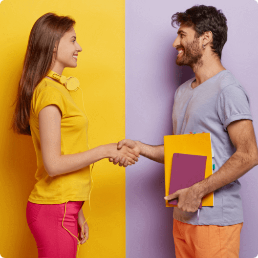 Man and woman shaking hands with colourful clothes.